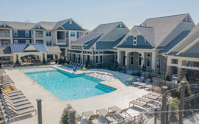 Spacious sparkling blue pool with large pool deck 