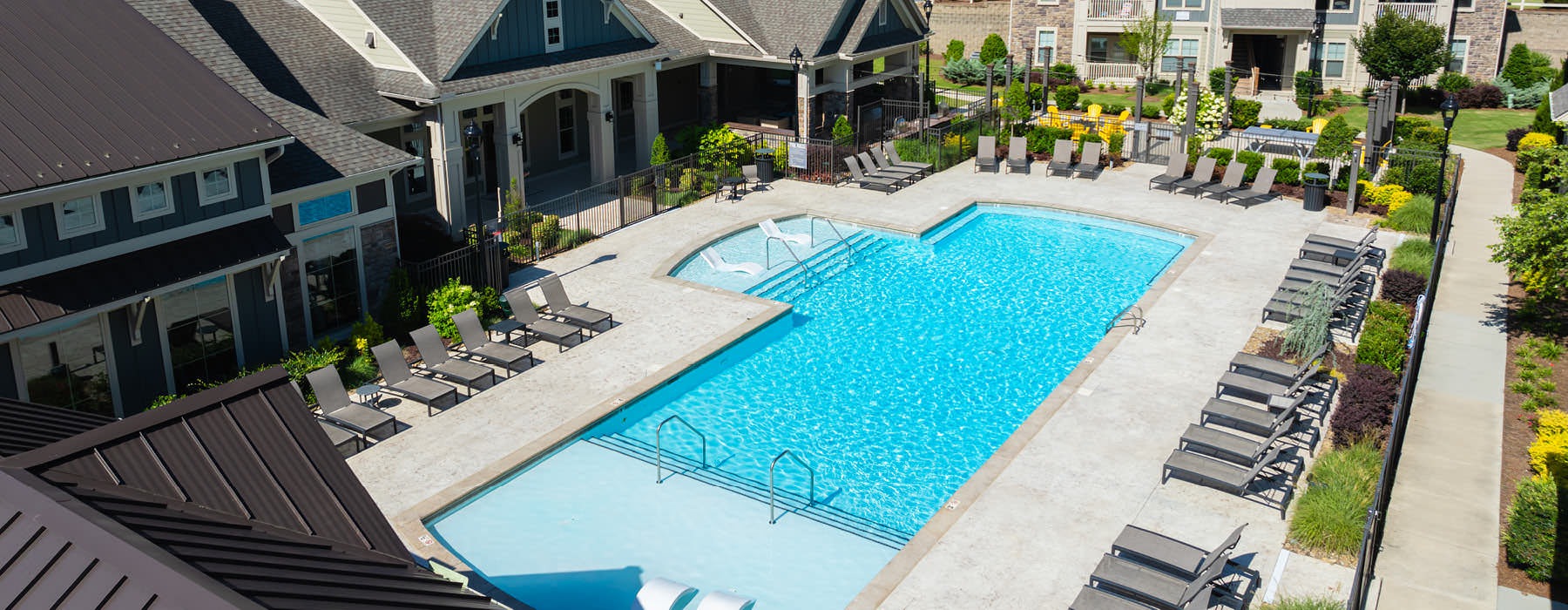 lounge chairs flank pool