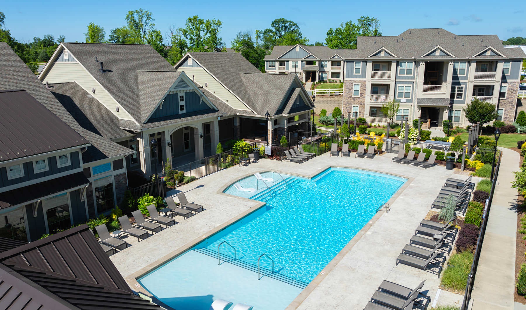 lounge chairs flank pool